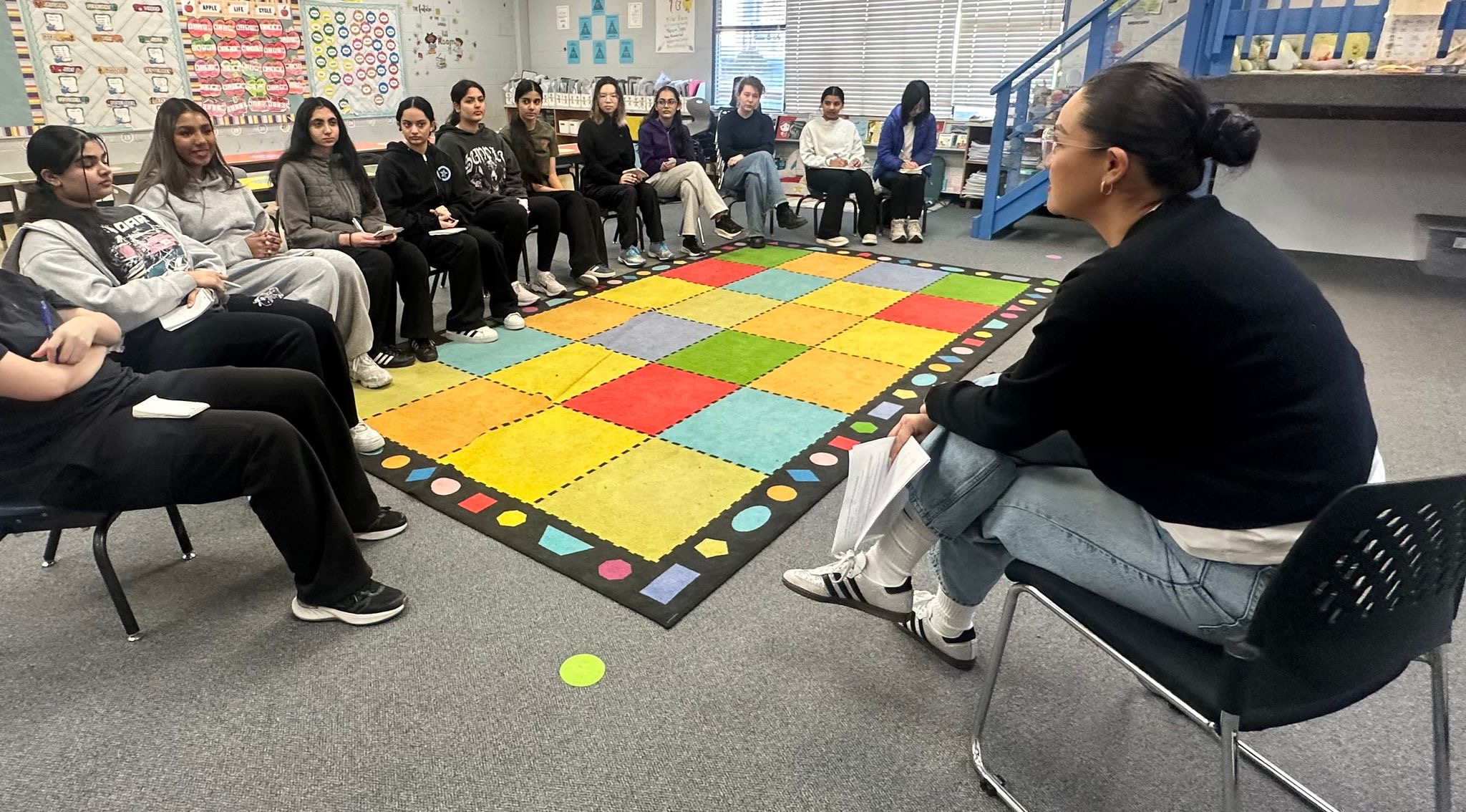 Dehara leading a session with young women