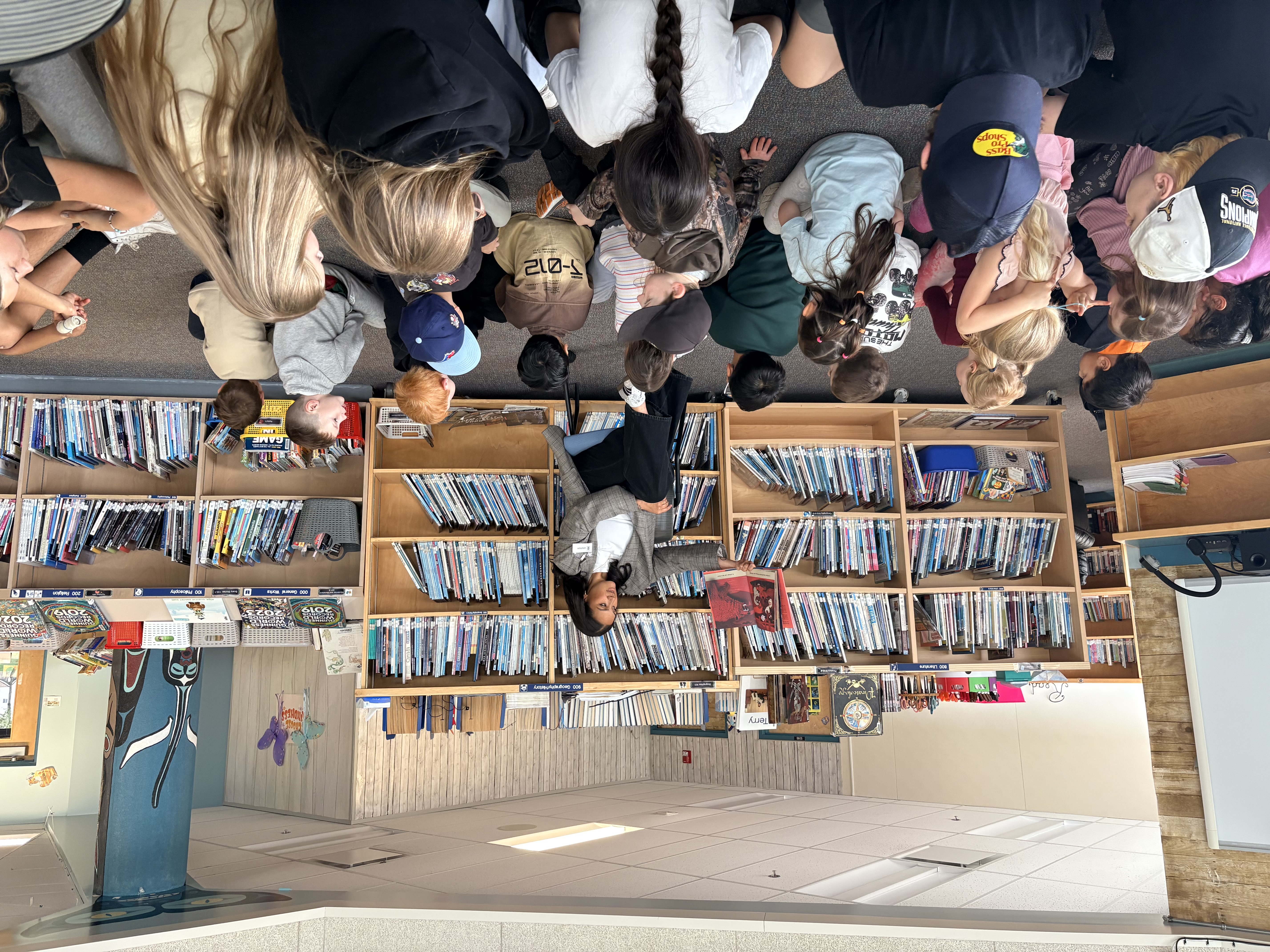 Dehara reading to children in school library